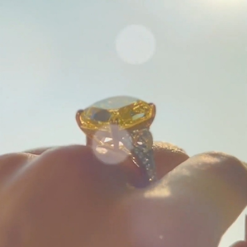 17.0 Carat Cushion Cut Yellow Diamond Ring With Two Hearts Side Stones