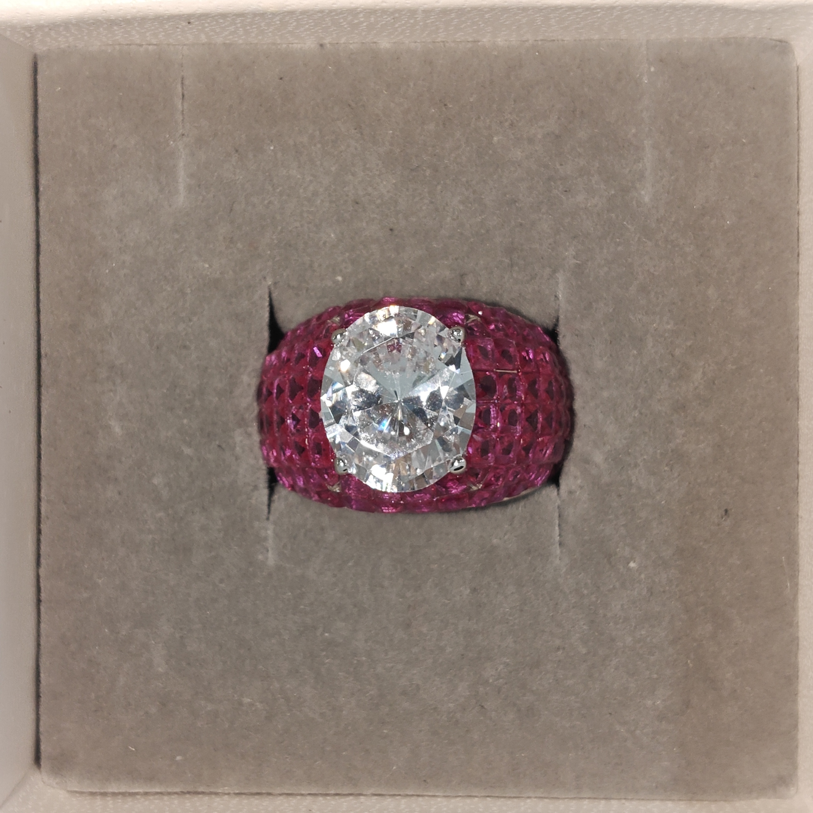 3ct Oval Cut Cocktail Ring Nestled Seamlessly in Invisible Set Rubies