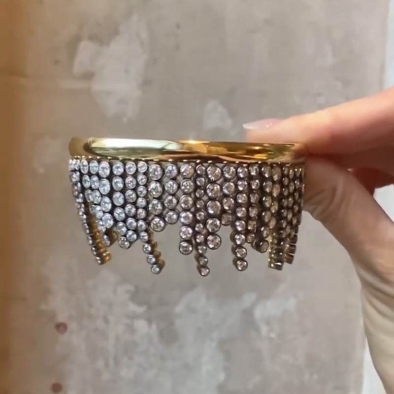 A Side Of Round Cut White Sapphires Yellow Gold Dangle Bangle