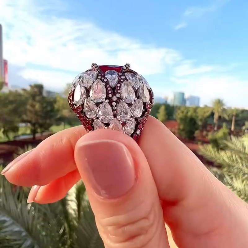 10ct Oval Cut Ruby With A Dome Of Pear Cut White Sapphires Paved Cocktail Ring