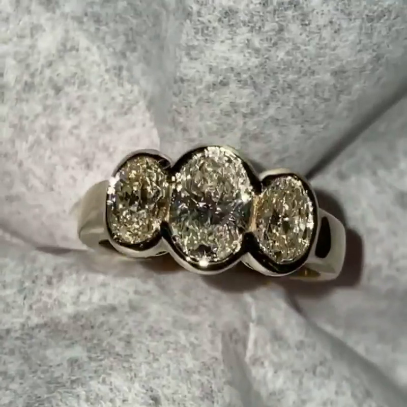 5ct Oval Cut White Sapphire Three Stone Bezel Set Yellow Gold Ring
