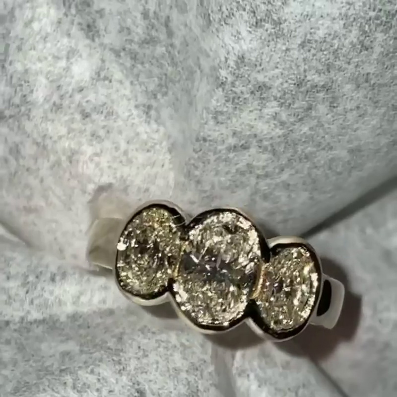 5ct Oval Cut White Sapphire Three Stone Bezel Set Yellow Gold Ring