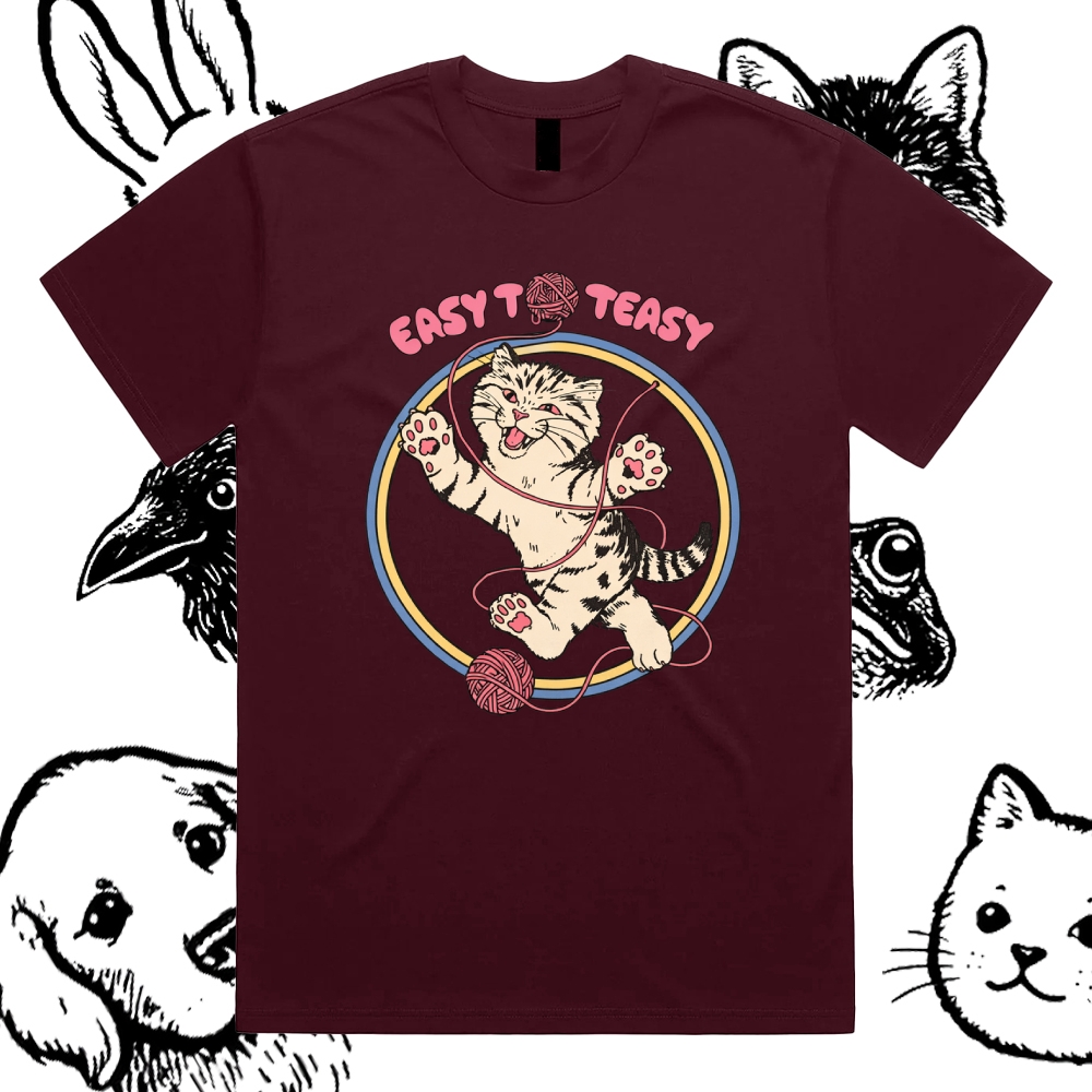A playful “EASY To EASY” graphic tee featuring a happy kitten tangled in yarn.