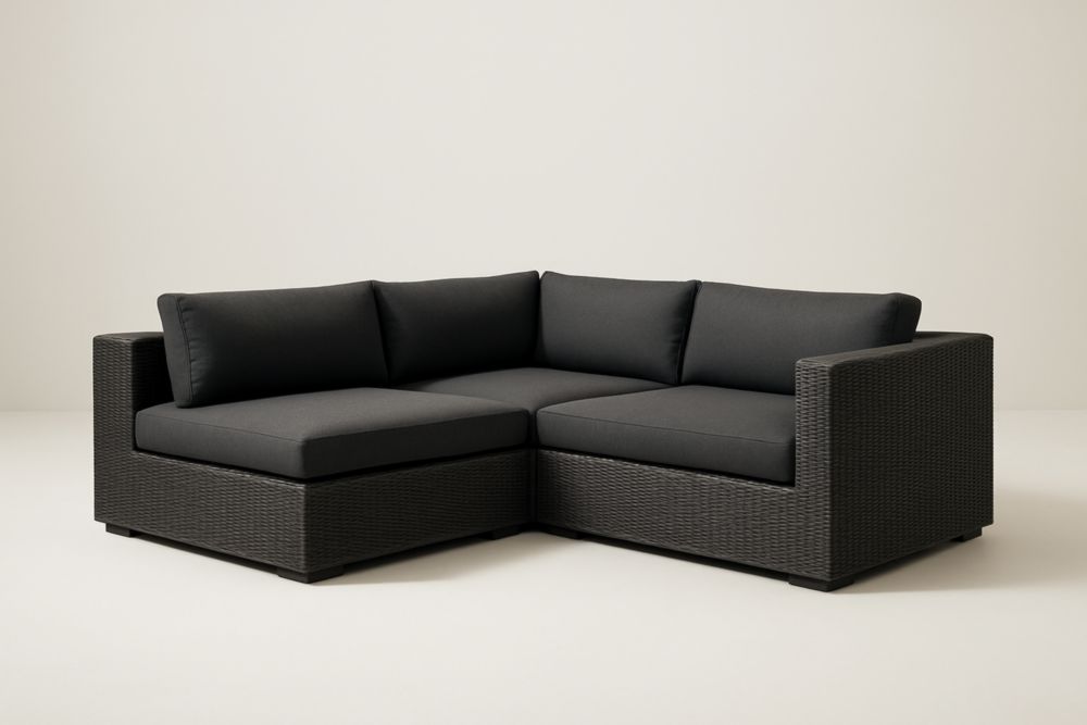 Divano angolare da giardino in rattan sintetico nero con cuscini antracite