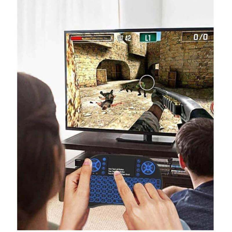 Mini i8 2.4GHz Wireless Backlit Keyboard with Touchpad – Ideal for Smart Android TV Boxes in gaming setup.