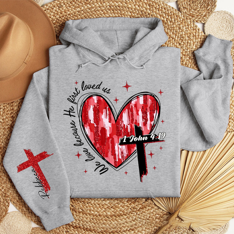 Personalized We Love Because He First Loved Us Classic Hoodies with Custom Name Heart Cross Valentine Bible Verse Hoodie Love Jesus Valentine Day Gift