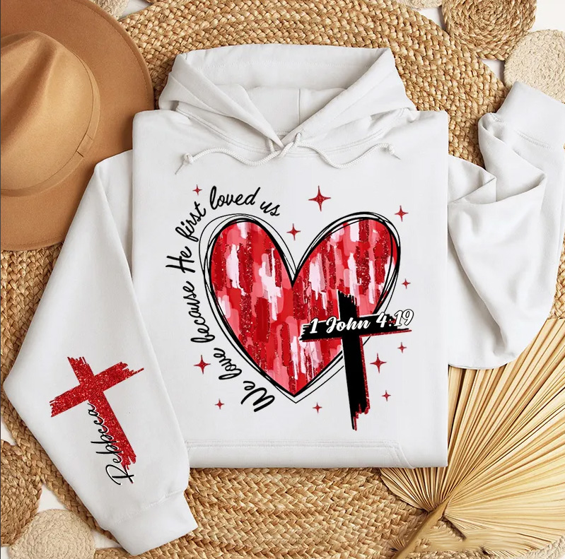Personalized We Love Because He First Loved Us Classic Hoodies with Custom Name Heart Cross Valentine Bible Verse Hoodie Love Jesus Valentine Day Gift