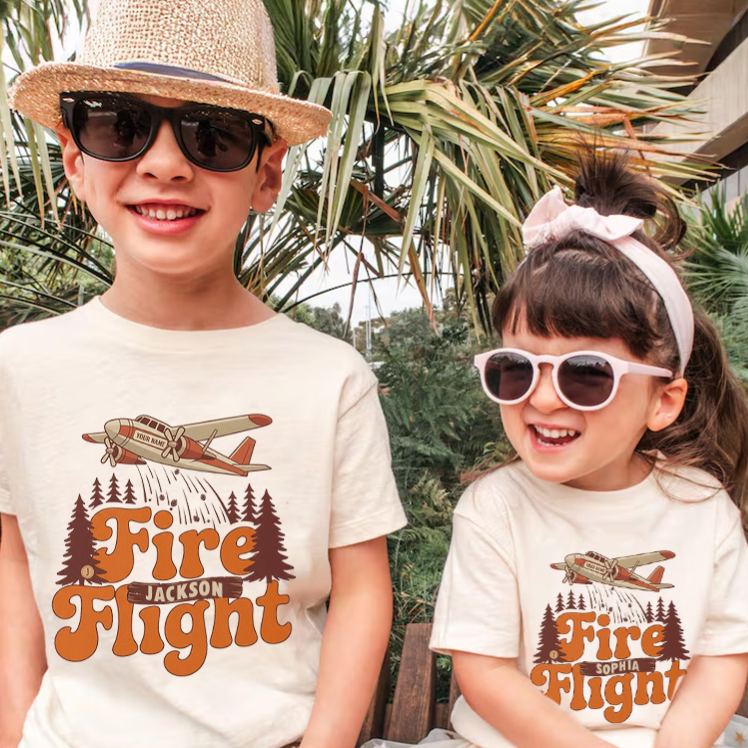 Personalized Fire Flight Kids T-Shirt with Custom Name and Retro Aerial Firefighter Plane Graphic for Little Adventurers Kids T-Shirt