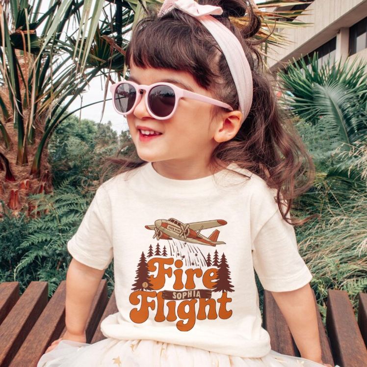 Personalized Fire Flight Kids T-Shirt with Custom Name and Retro Aerial Firefighter Plane Graphic for Little Adventurers Kids T-Shirt