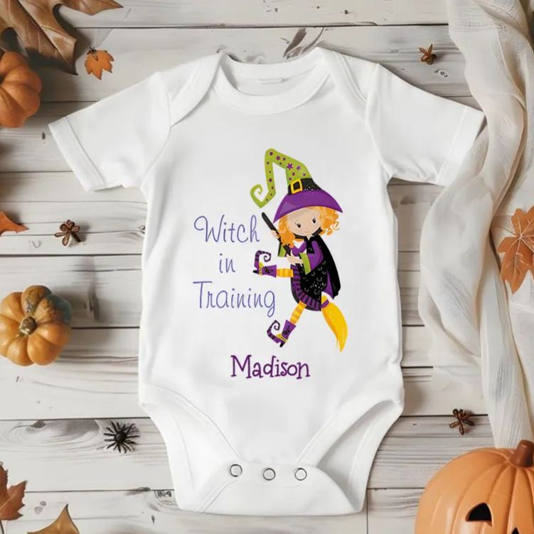 Personalized Witch in Training Featuring Adorable Witch Motif and Customizable Name for Baby’s Halloween Celebration Baby Onesie