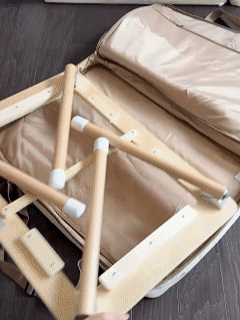 Foldable sensory table being packed into its storage bag
