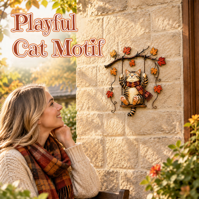 Swinging autumn cat decoration displayed in a fall setting