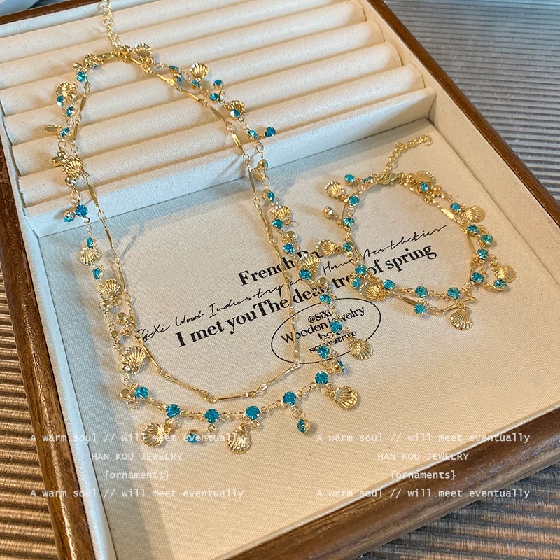 Двуслоен комплект колие и гривна със син циркон и мида