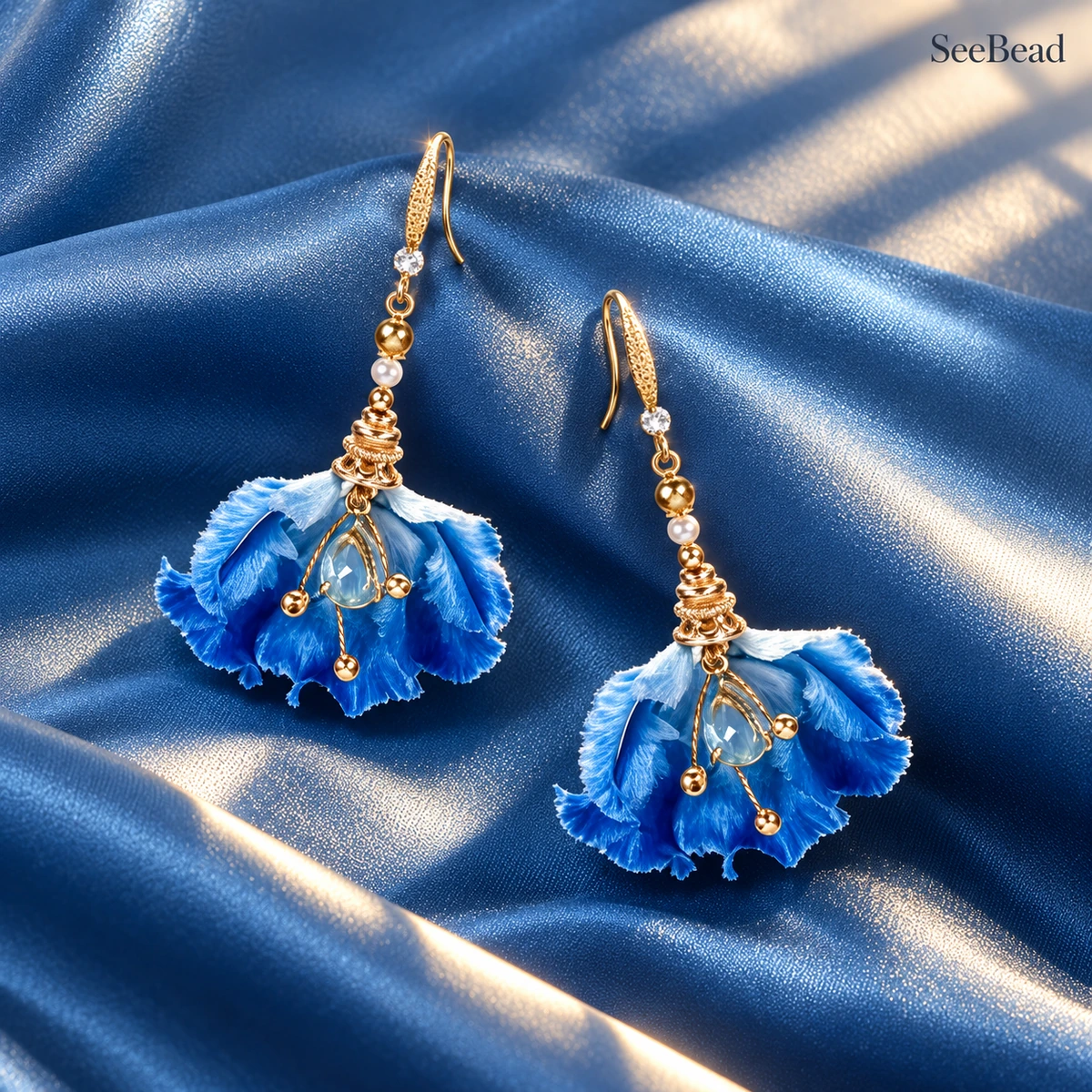 Water Rhythm Iris handmade silk earrings on blue satin
