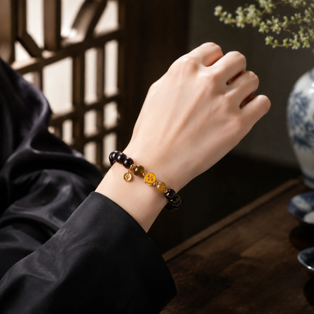 Dark wood and honey bead bracelet worn on wrist