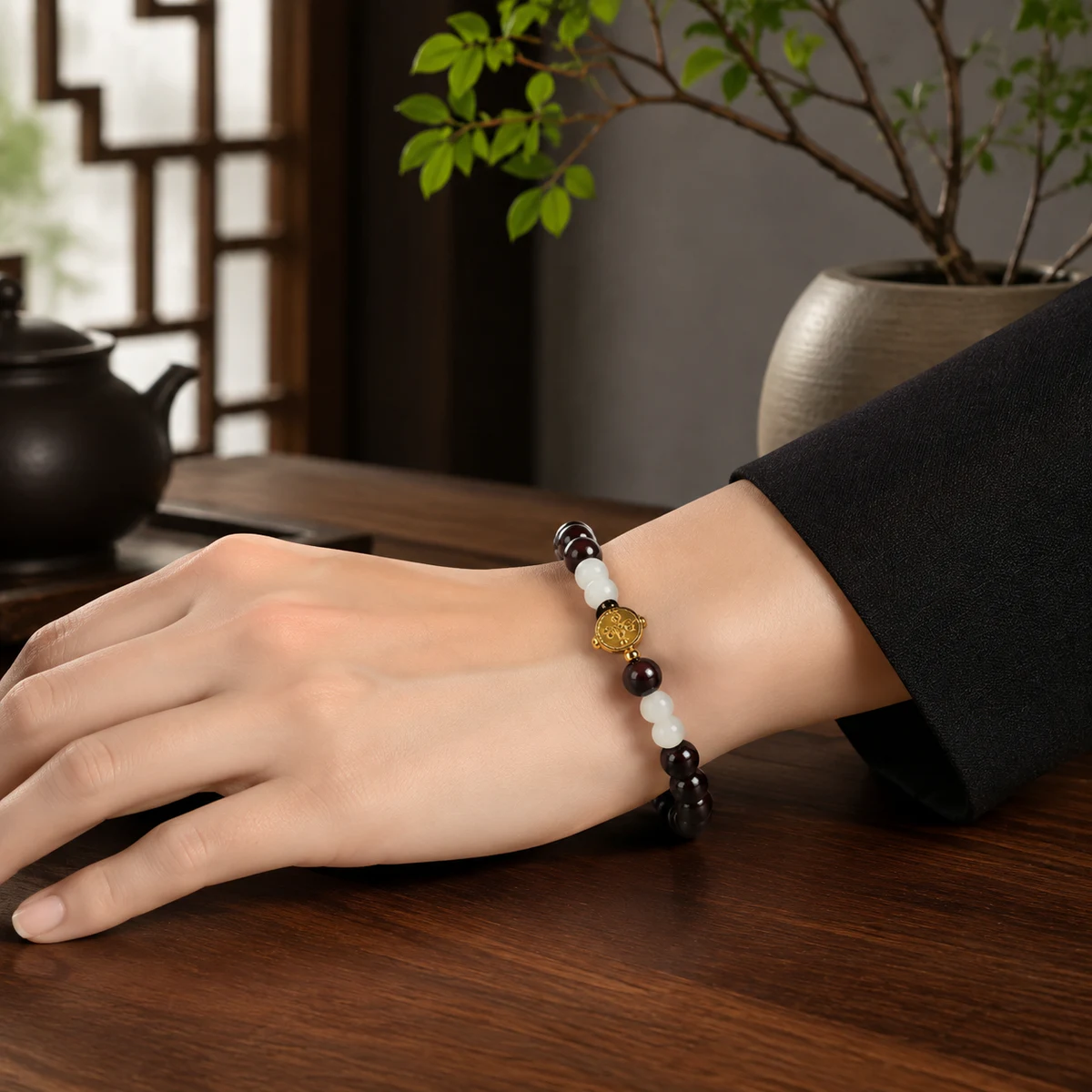 Dark wood and white bead bracelet worn on wrist