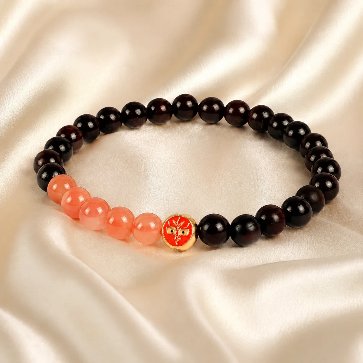 Dark wood and coral bead bracelet on silk