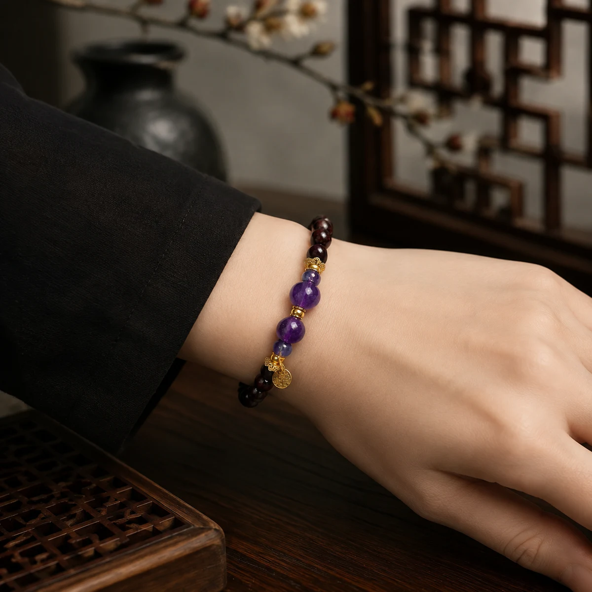 Purple gemstone and dark wood bead bracelet worn on wrist