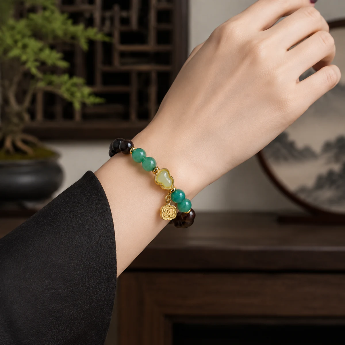Wood and green jade bead bracelet worn on wrist