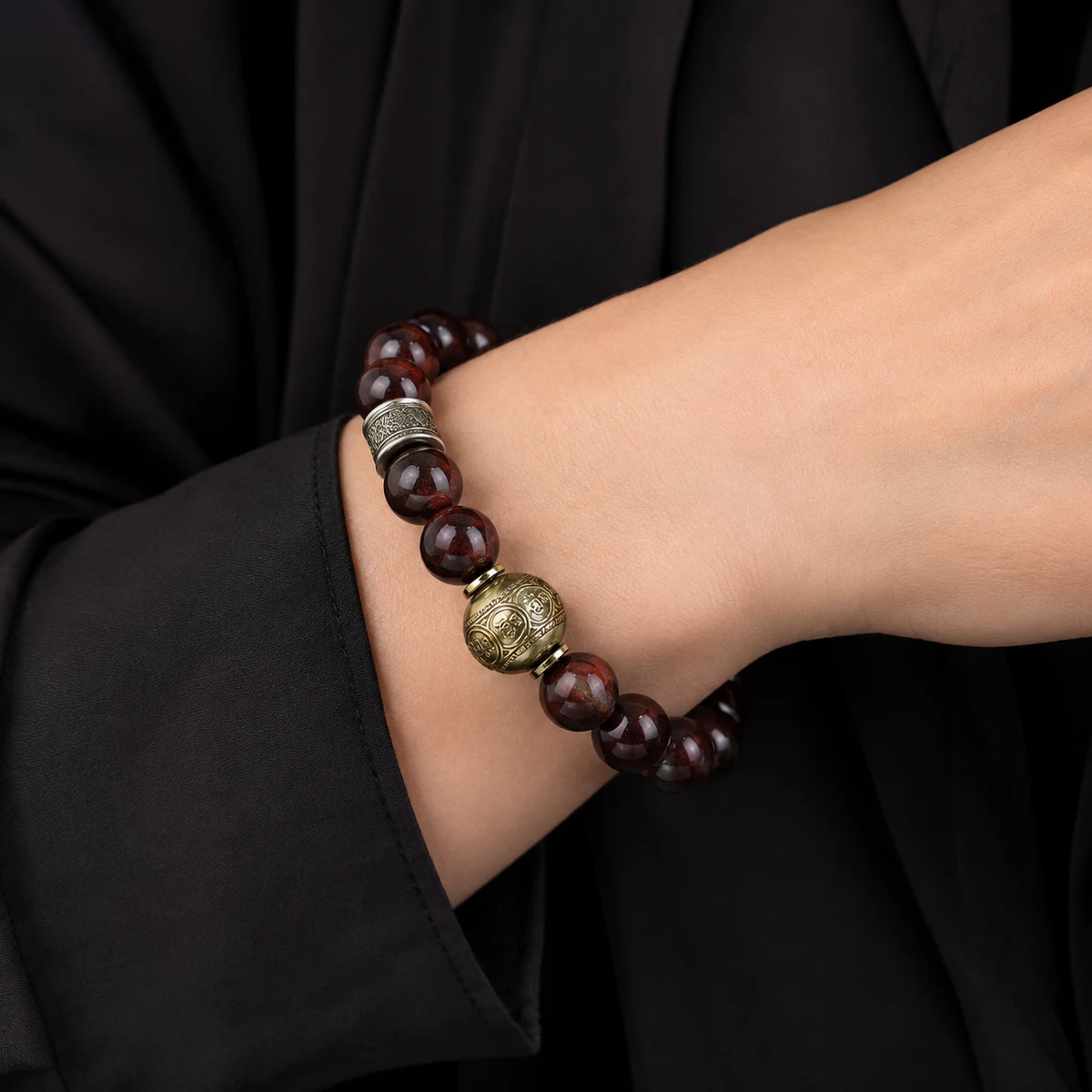 Dark wood bead bracelet worn on wrist