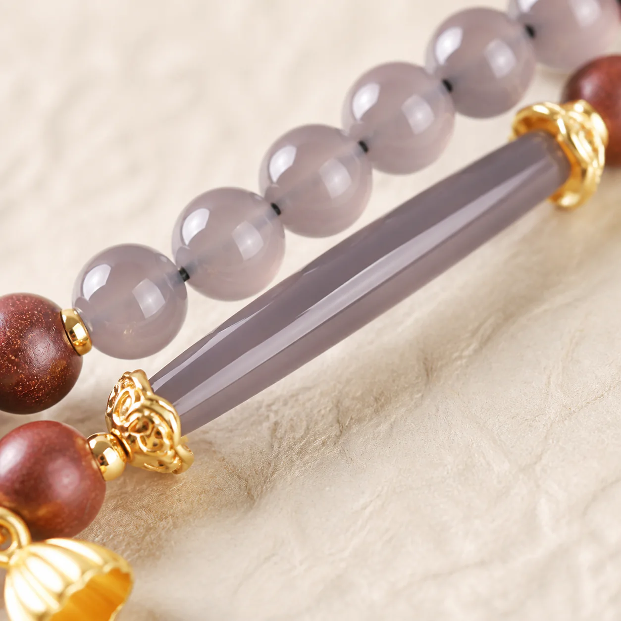 Pink gemstone bead bracelet centerpiece detail