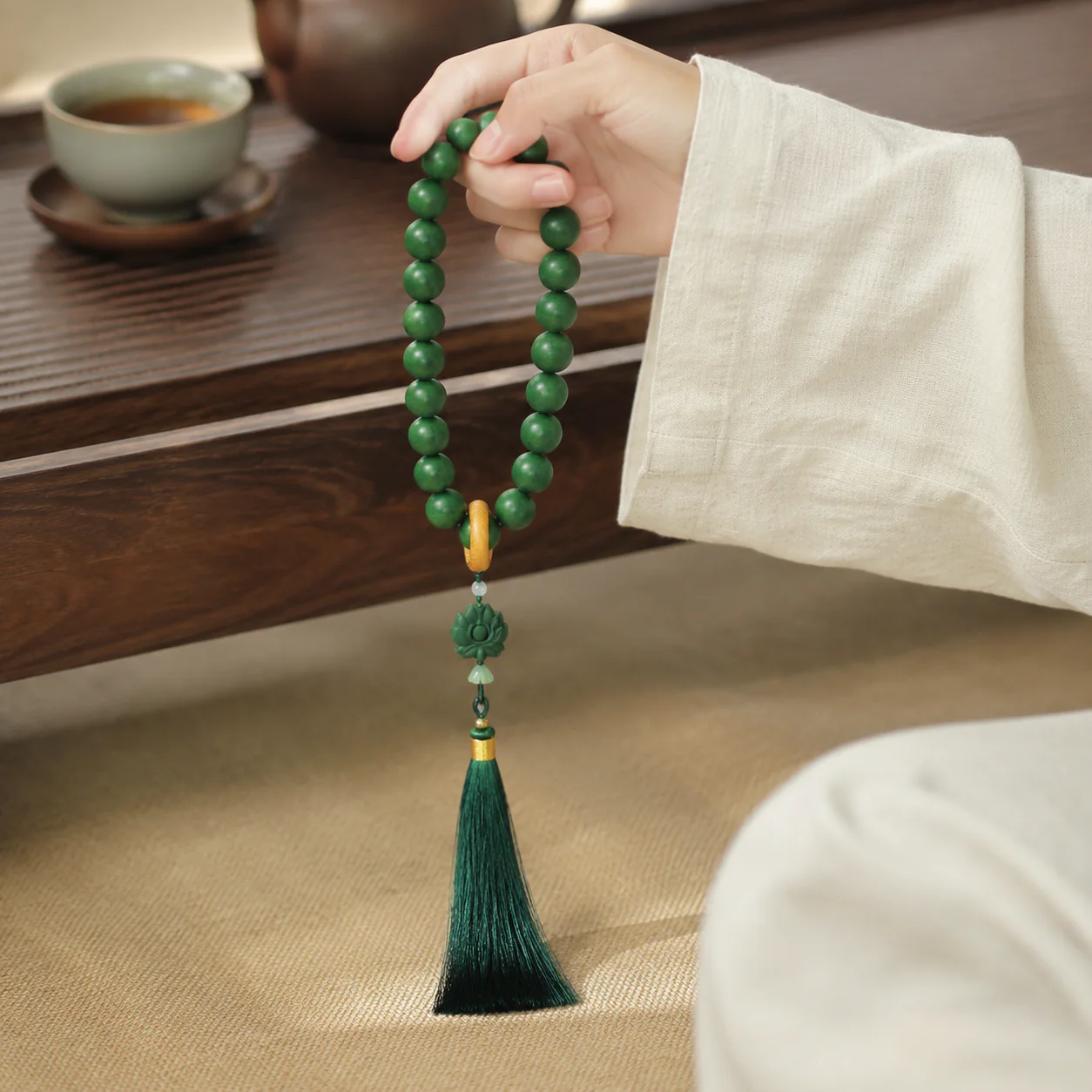 Green incense prayer beads held with linen