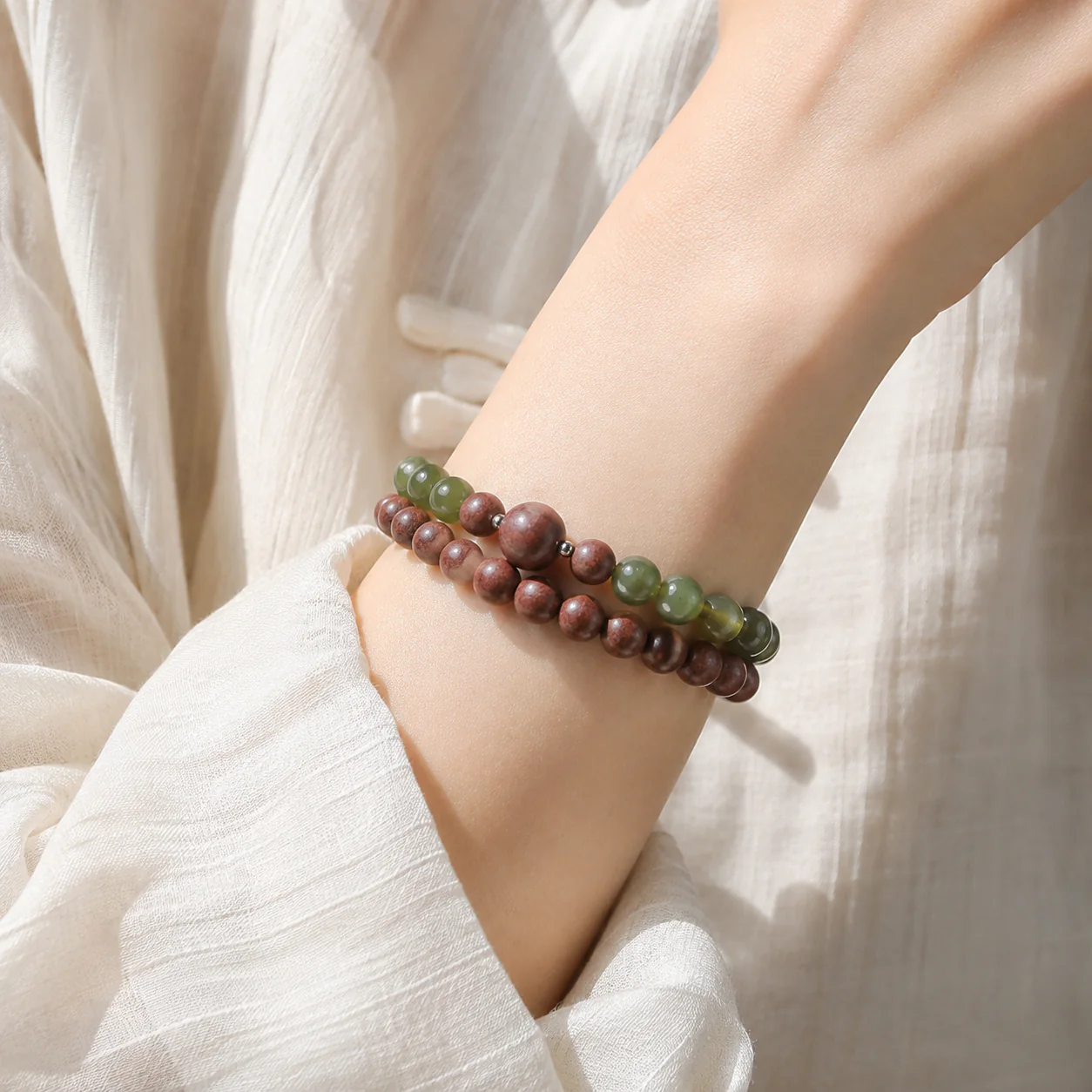 Rosewood-tone incense bead bracelet worn with linen