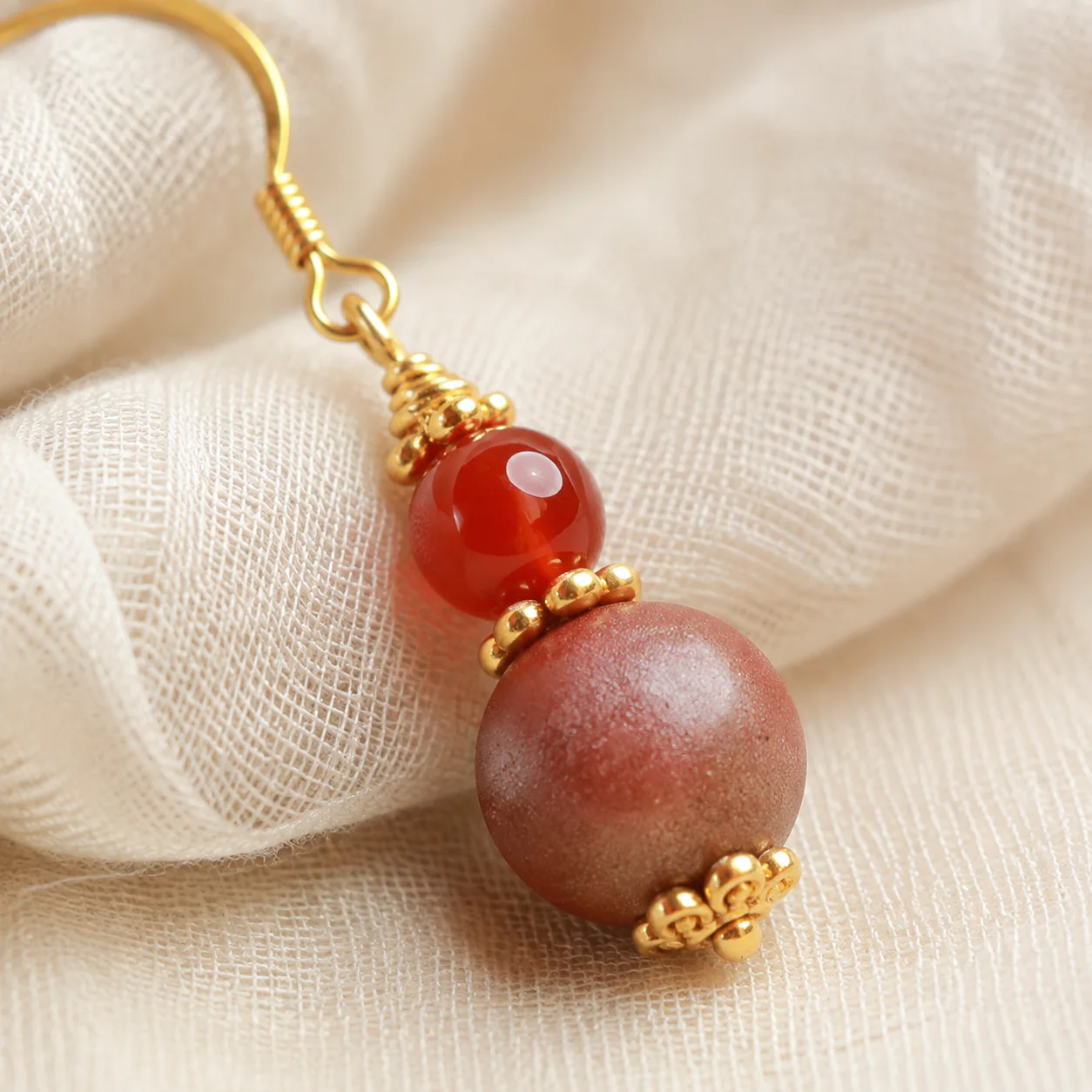 Warm-tone incense drop earrings bead detail