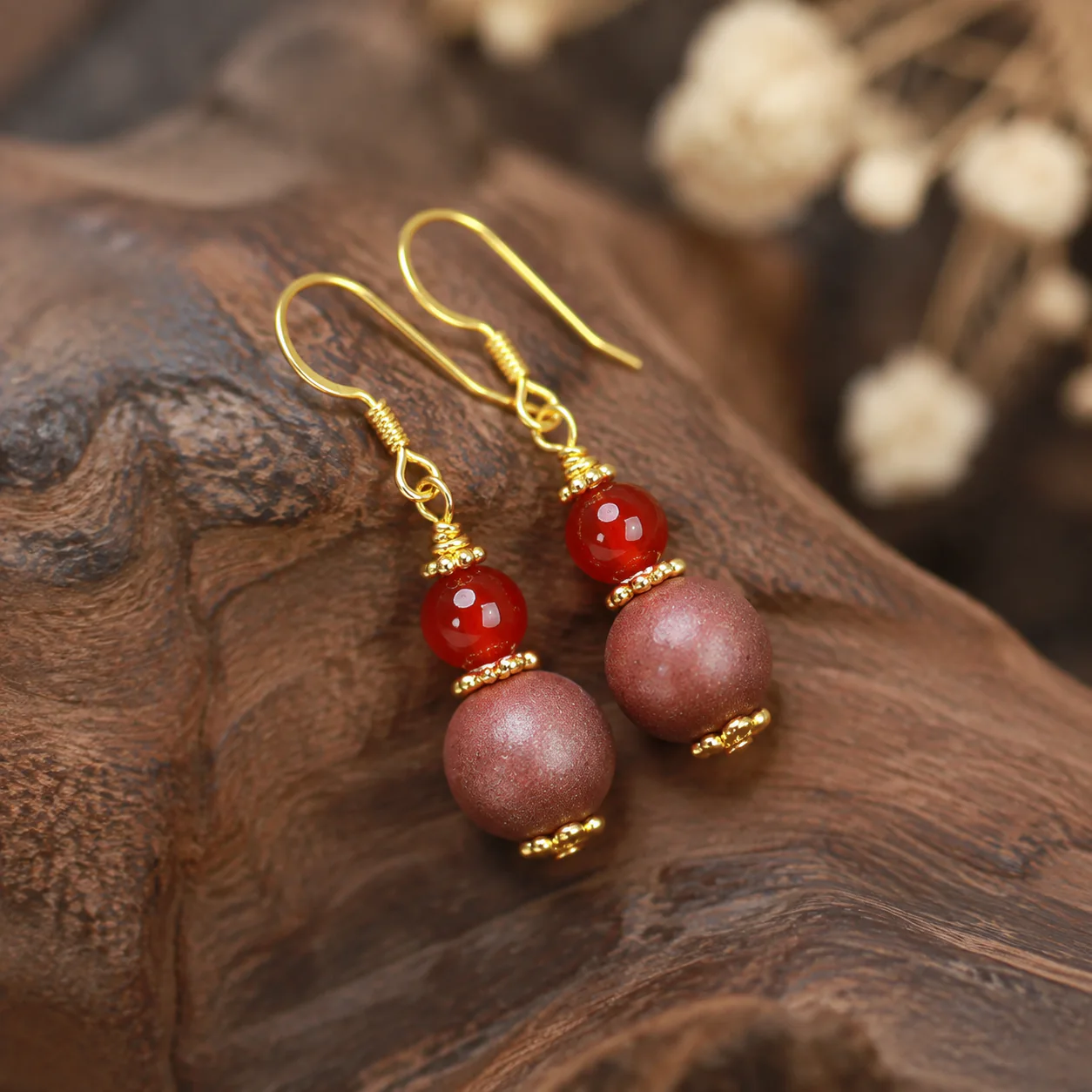 Warm-tone incense drop earrings gold hook detail