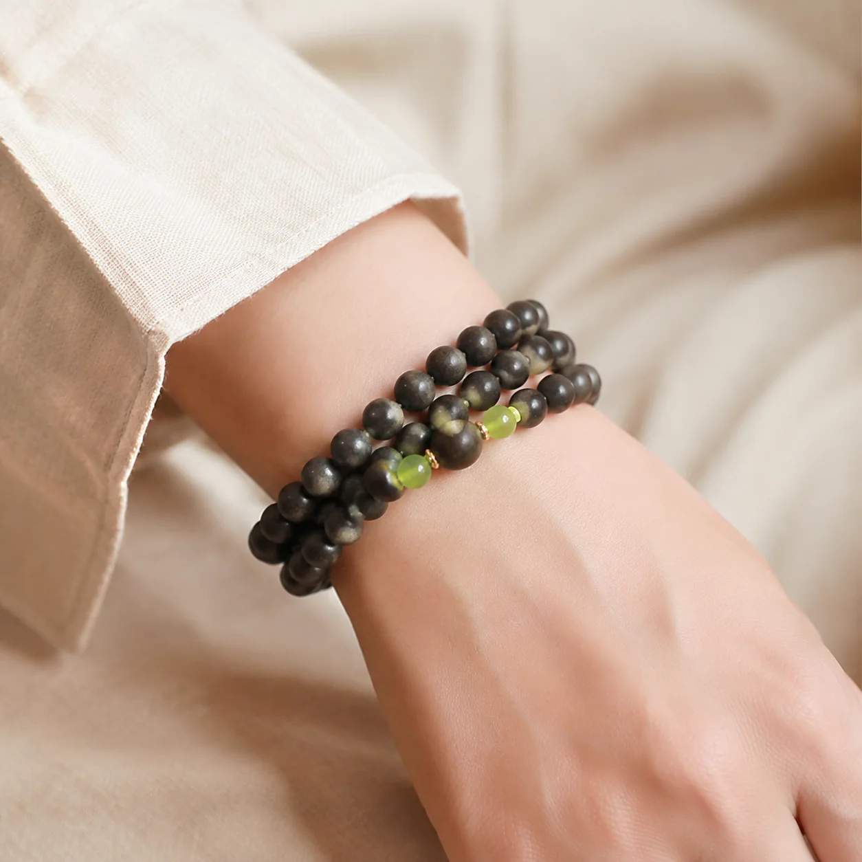 Dark incense bead multi-wrap bracelet worn with linen