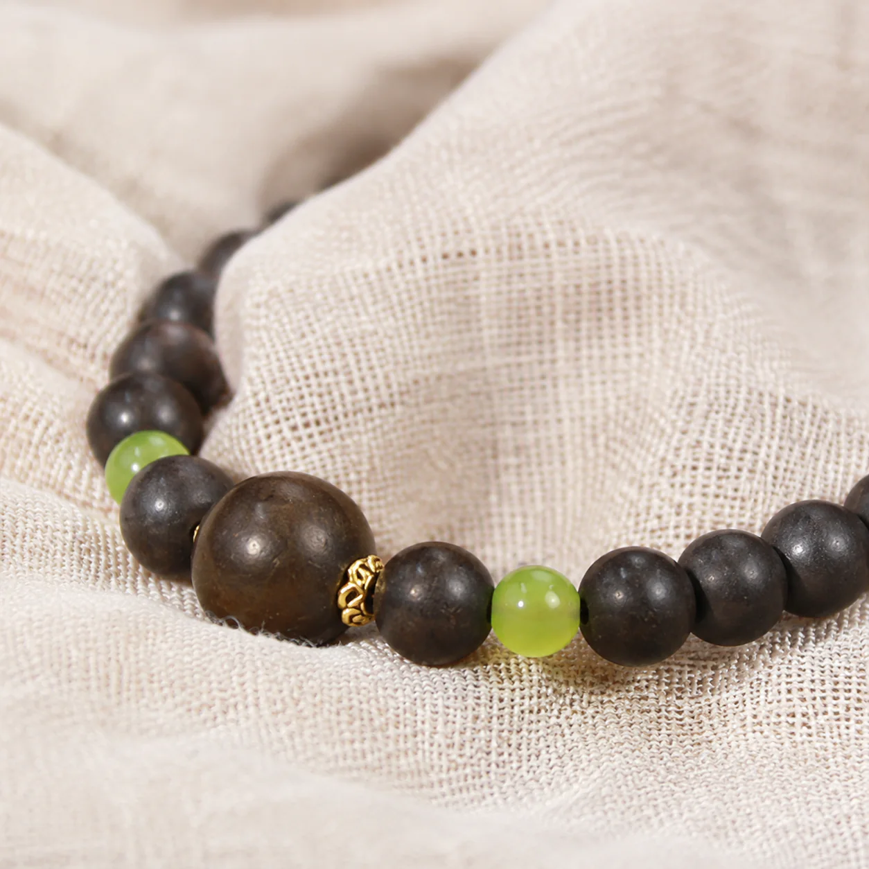 Dark incense bead bracelet green accent detail