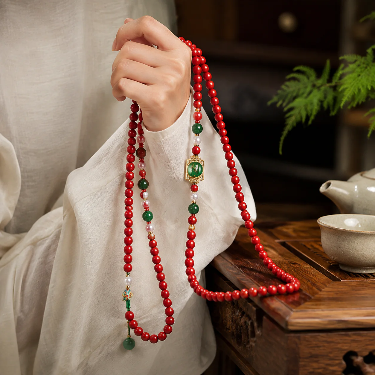 Red incense bead mala draped with linen