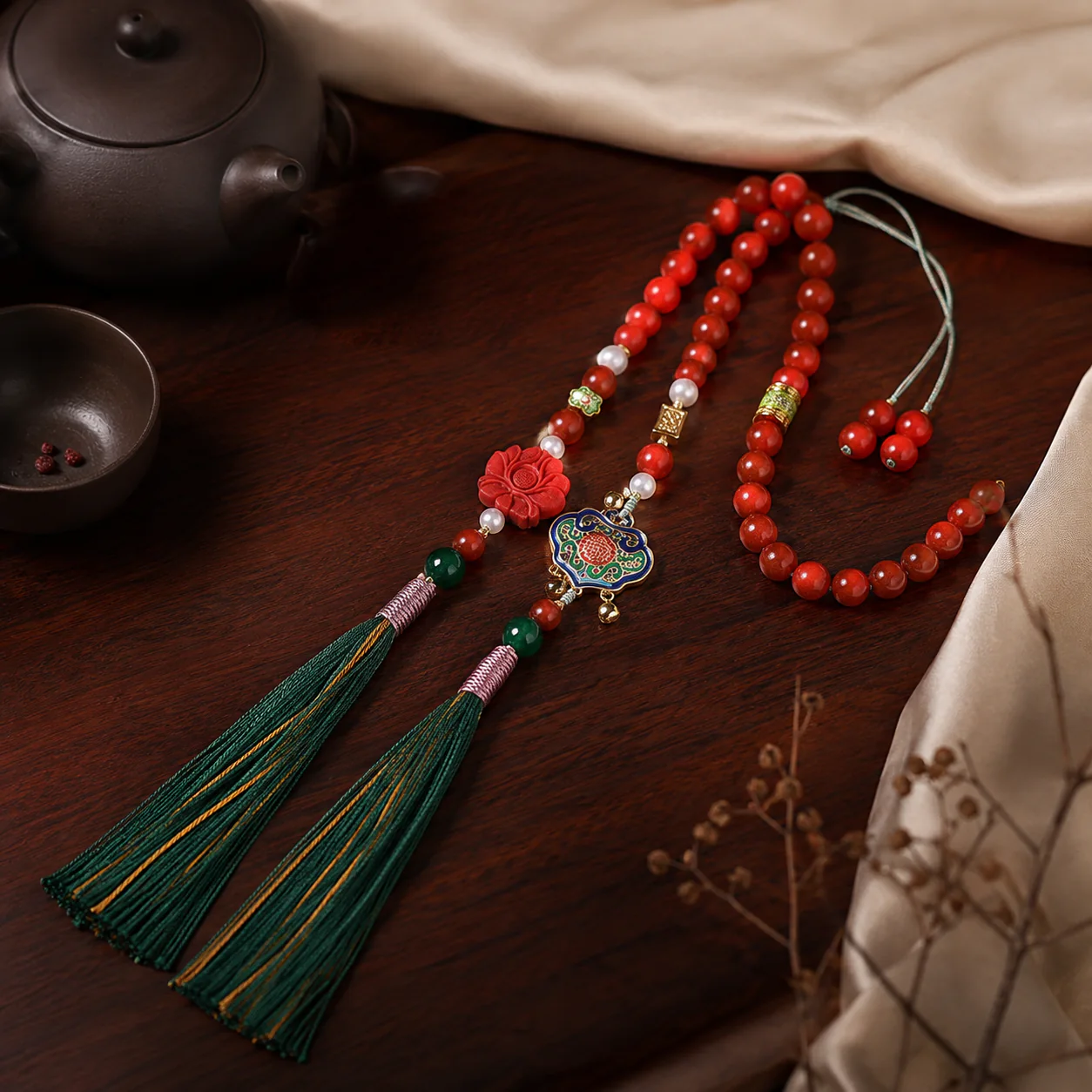 Red bead mala with green tassels in a new Chinese setting