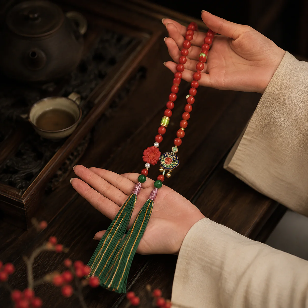 Red bead mala with green tassels held with linen