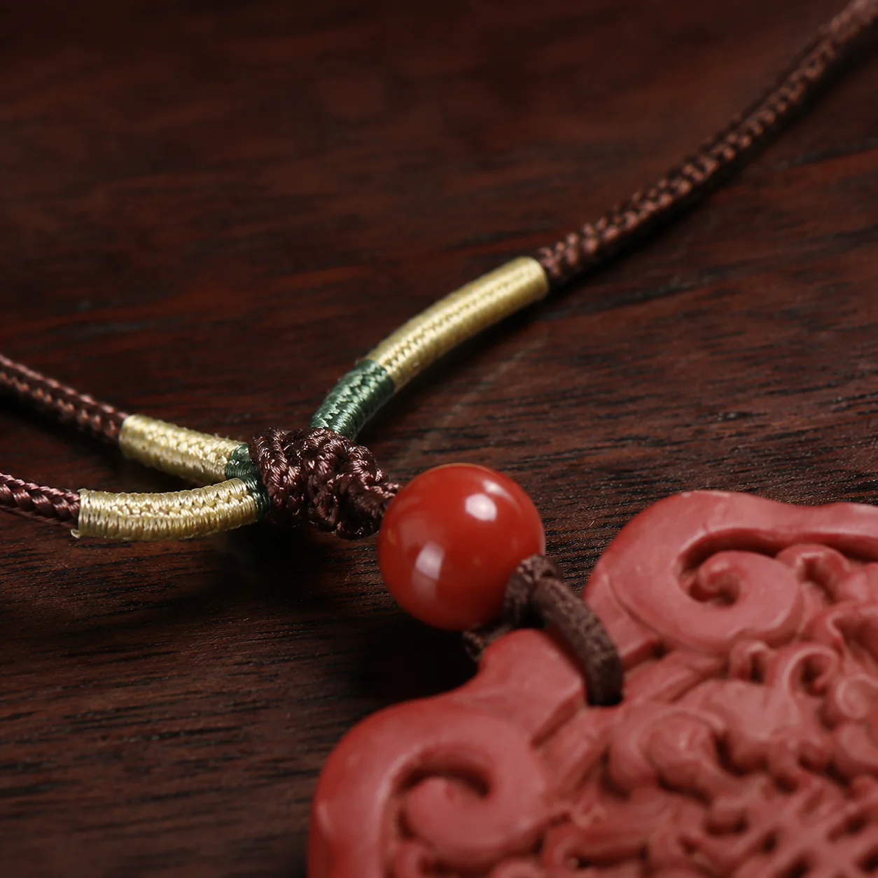 Red carved pendant necklace cord detail