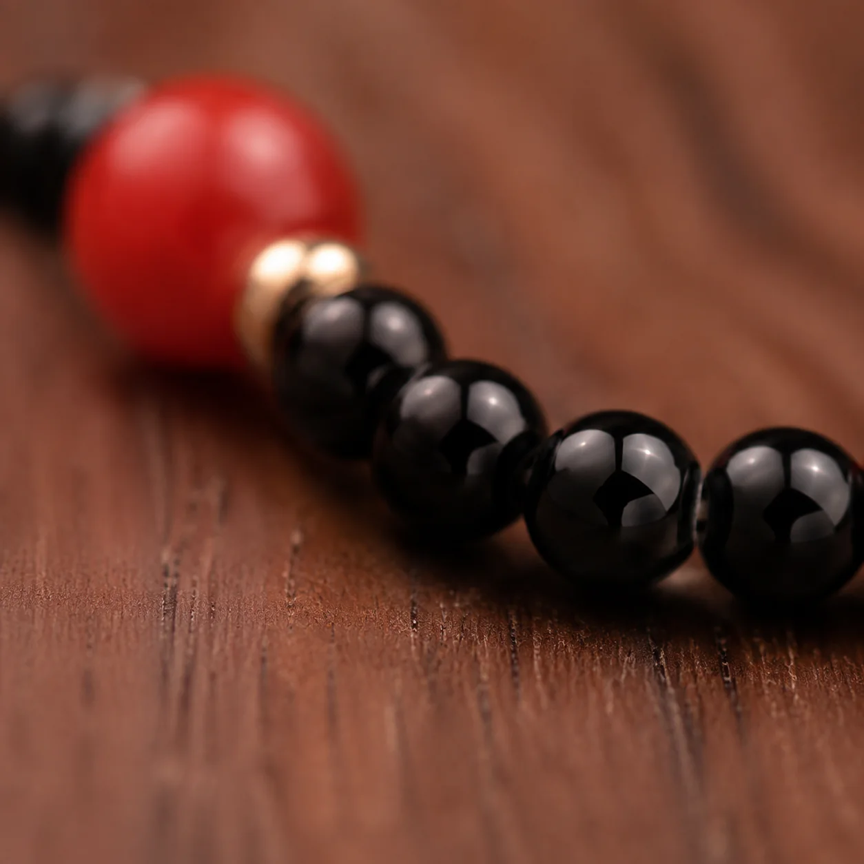 Red and black bead ring worn with linen