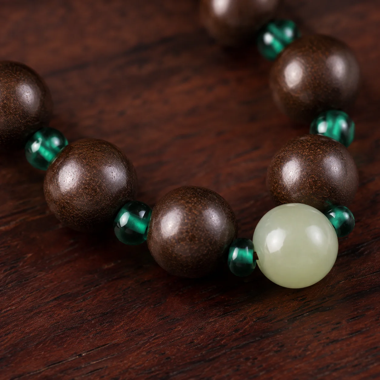 Dark wood and green bead necklace detail