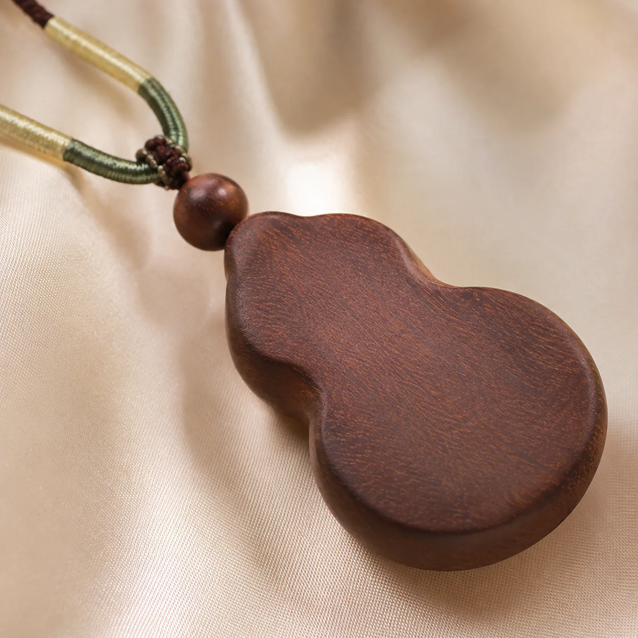Dark wood gourd pendant necklace detail