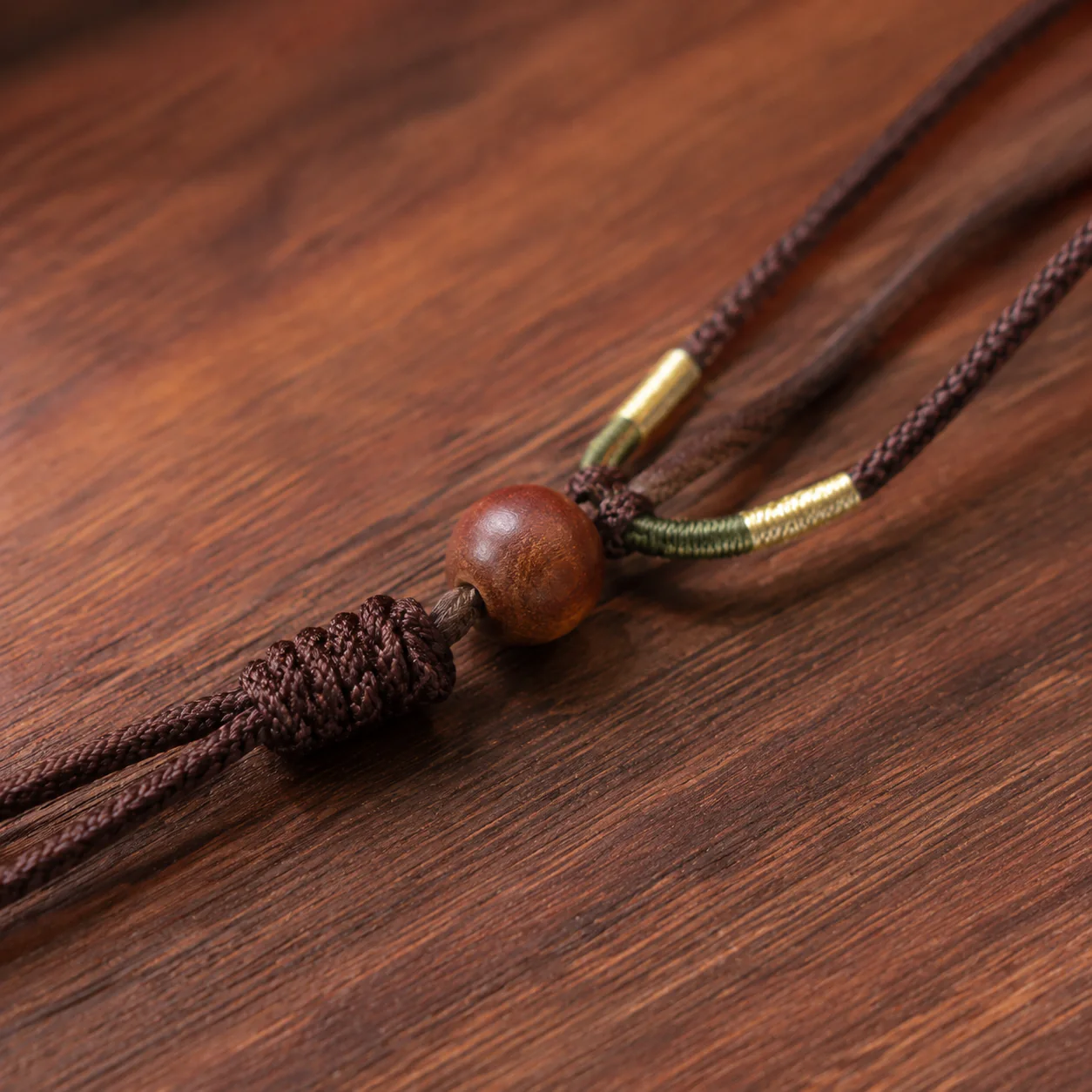 Dark wood necklace cord and bead detail