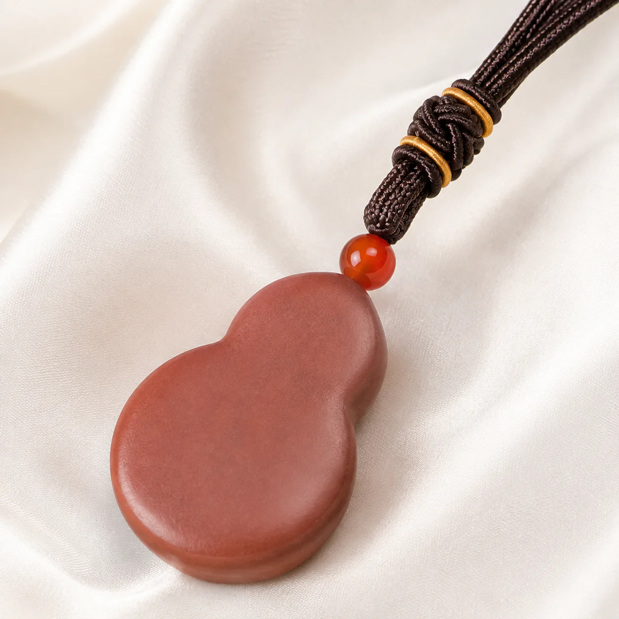 Terracotta gourd pendant and cord detail