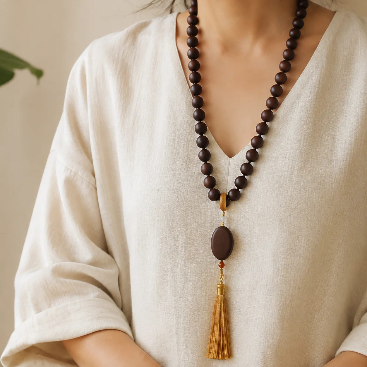 Dark wood bead tassel necklace worn with linen