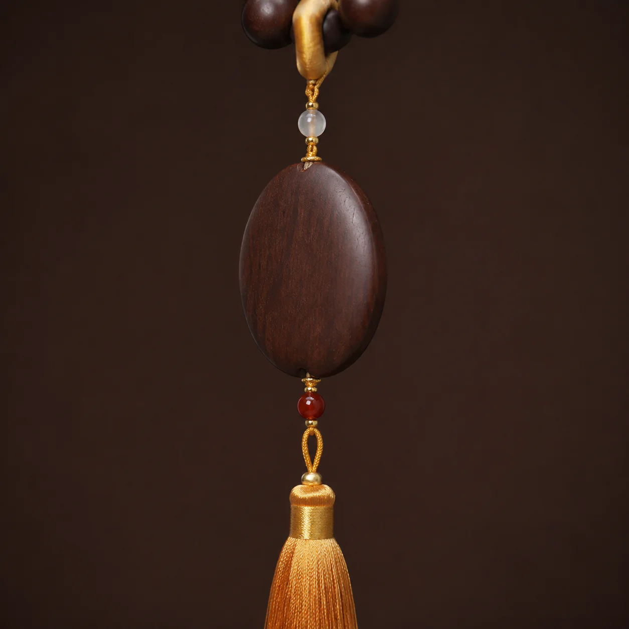 Dark wood tassel necklace pendant detail