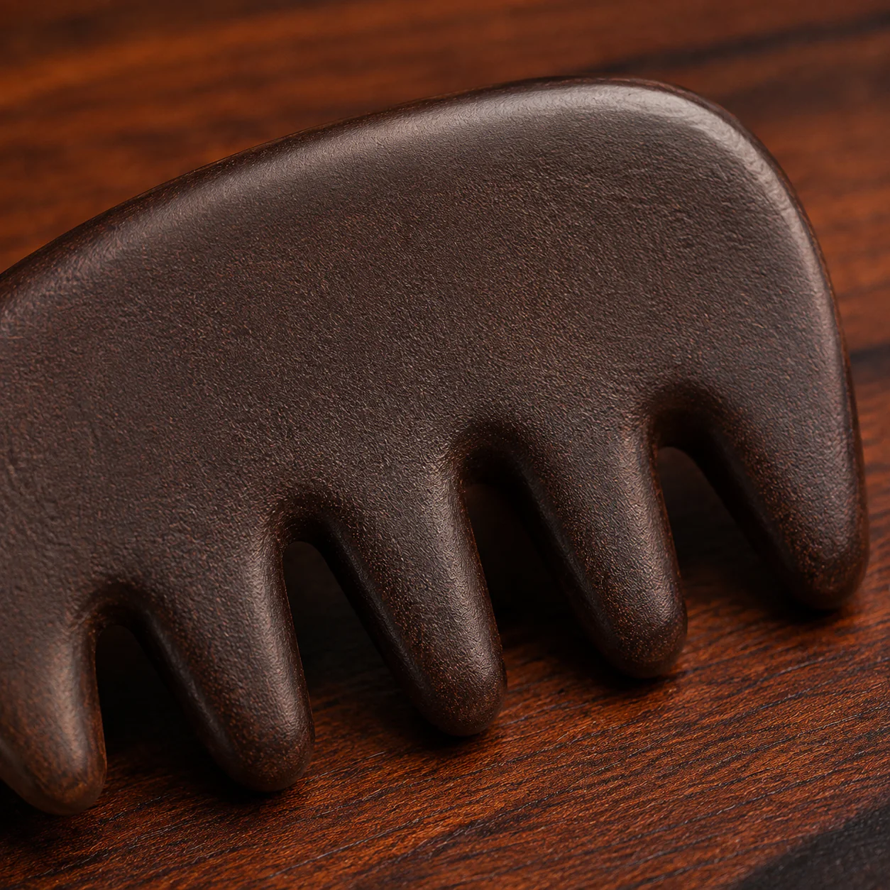 Polished dark wood comb detail