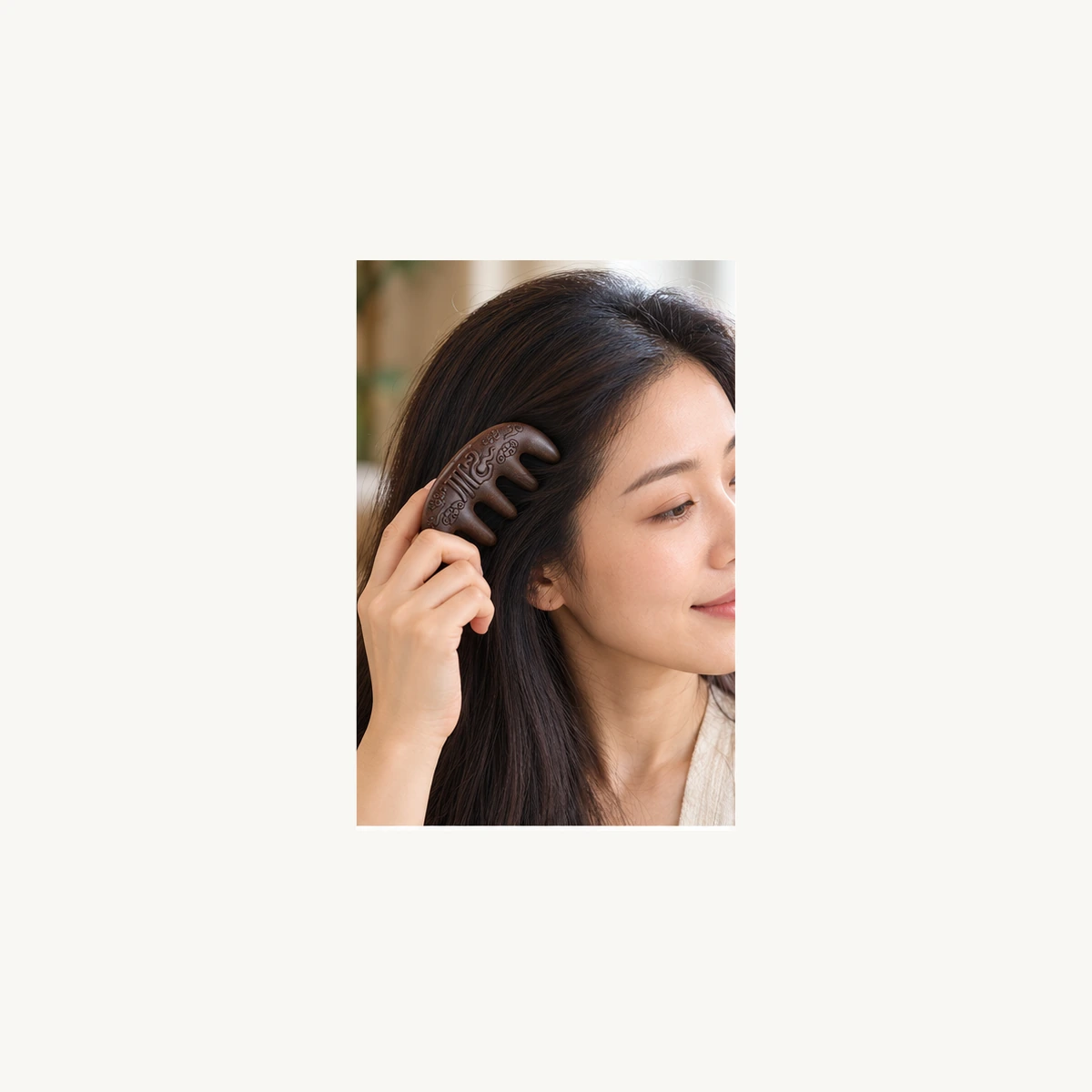 Woman using a carved Hexiang incense comb through her hair