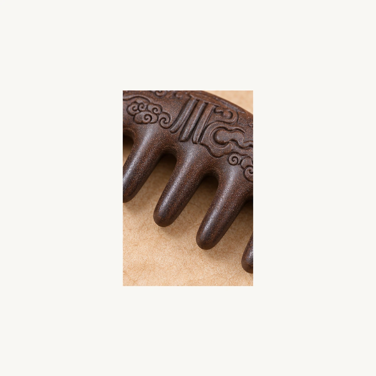 Close detail of the carved motif and rounded teeth
