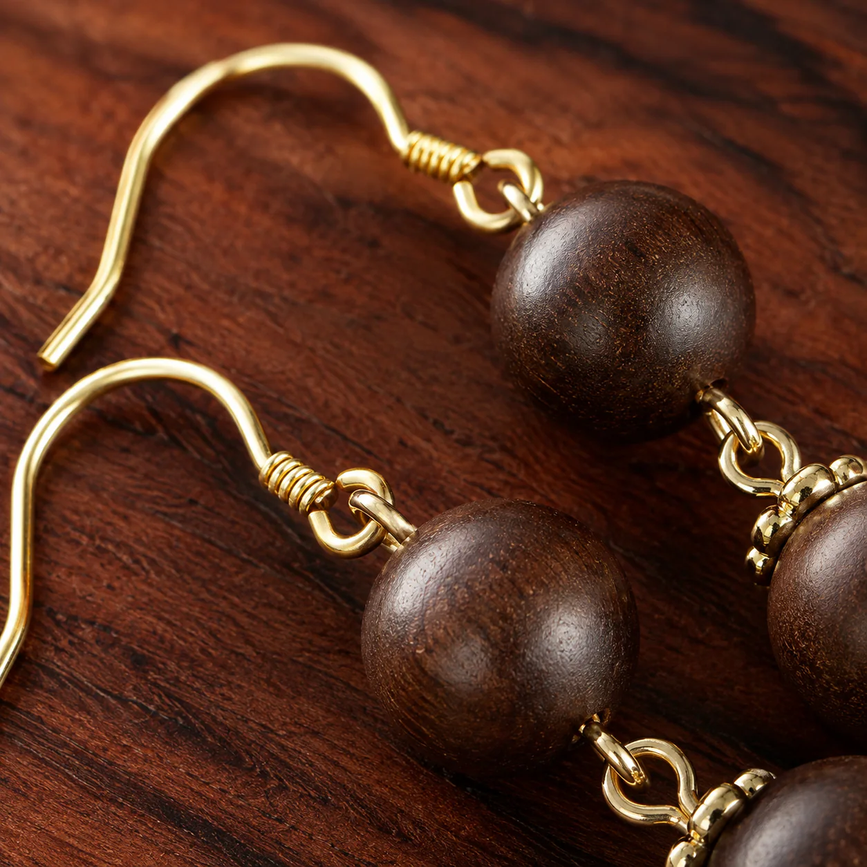 Brown wood bead earrings and gold hook detail