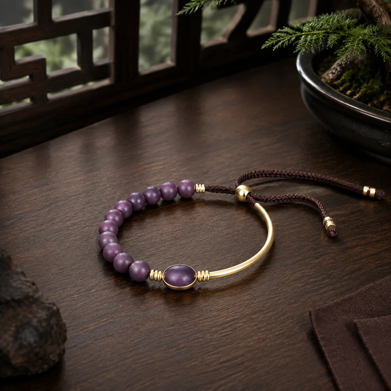 Plum wood bead and gold bangle bracelet in a refined setting