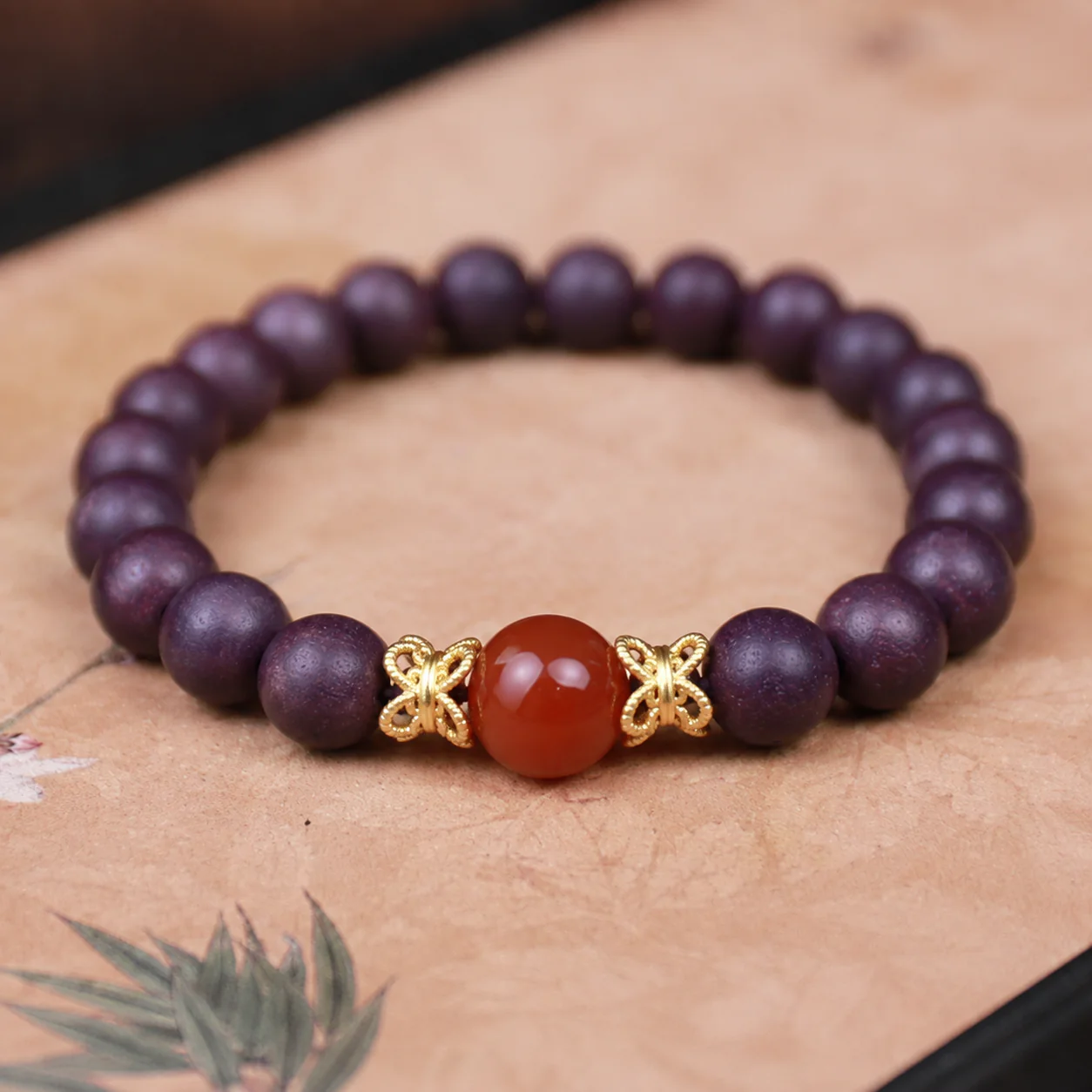 Plum wood bead and red agate bracelet material detail