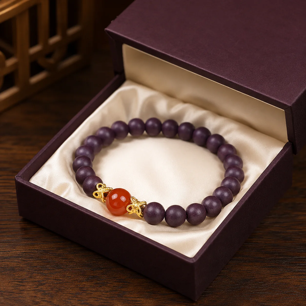 Plum wood bead bracelet with red agate accent gift presentation