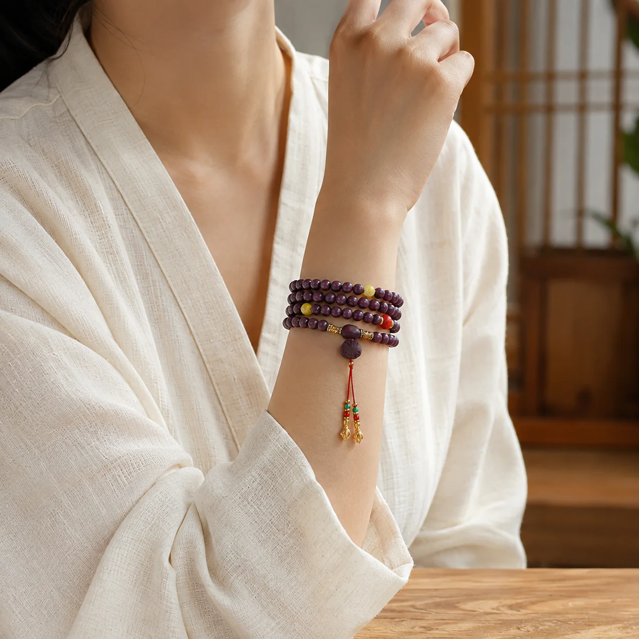 Plum wood bead prayer strand worn with linen